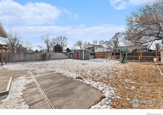 view of yard featuring a playground and a storage unit