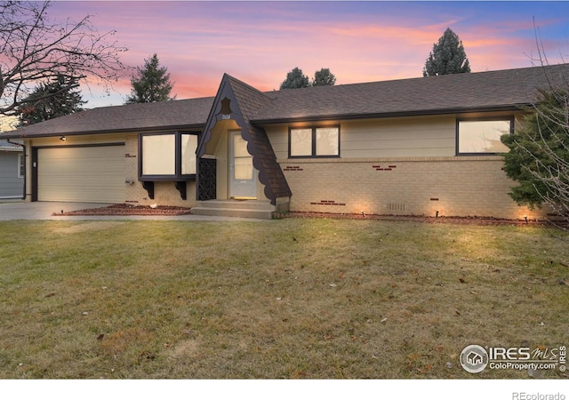 view of front of house with a lawn and a garage