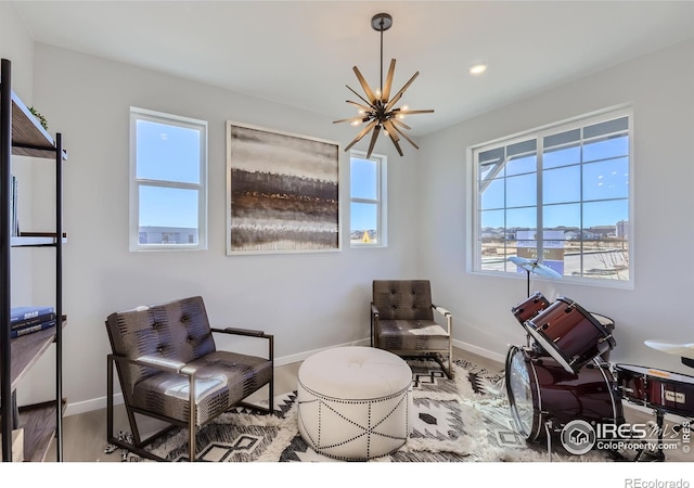 living area with hardwood / wood-style floors and a notable chandelier