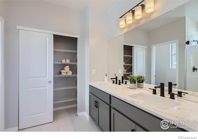 bathroom featuring tile patterned flooring and vanity