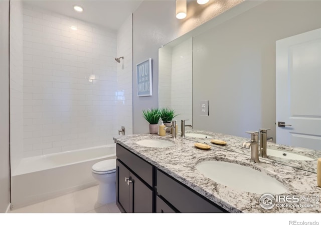 full bathroom with tile patterned floors, vanity, toilet, and tiled shower / bath