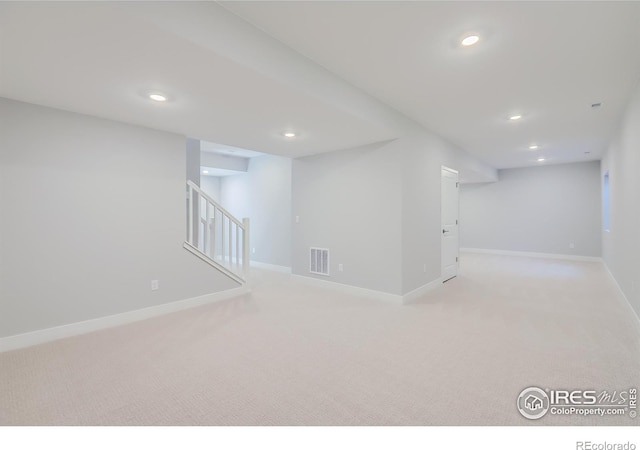 basement featuring light colored carpet