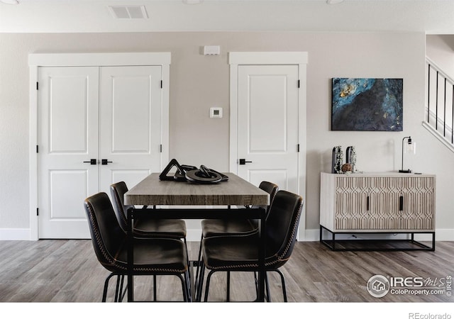 dining space featuring wood-type flooring