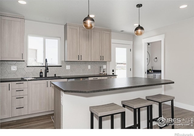 kitchen with sink, hanging light fixtures, and light brown cabinets