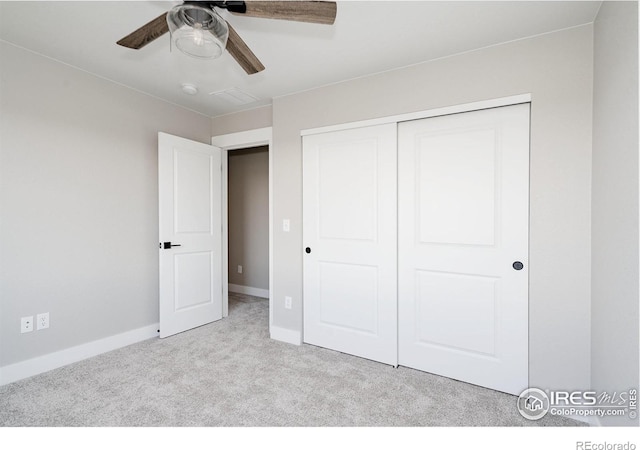 unfurnished bedroom featuring light carpet, ceiling fan, and a closet