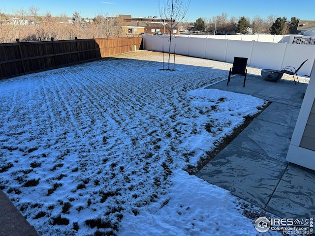 view of yard layered in snow