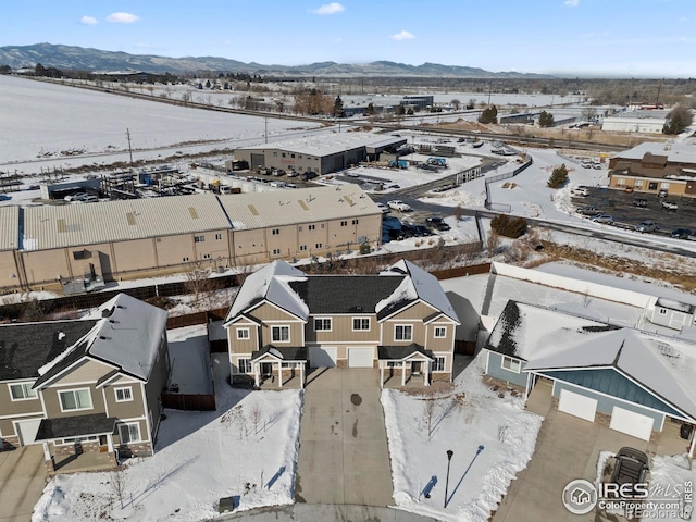 snowy aerial view with a mountain view