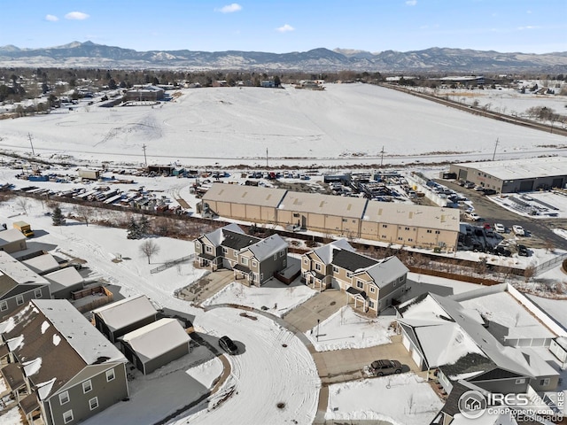 snowy aerial view with a mountain view