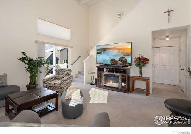 carpeted living room with a towering ceiling