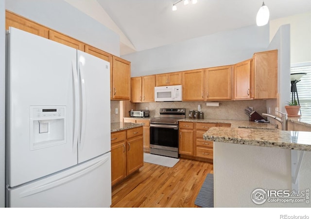 kitchen with tasteful backsplash, white appliances, vaulted ceiling, light hardwood / wood-style flooring, and hanging light fixtures