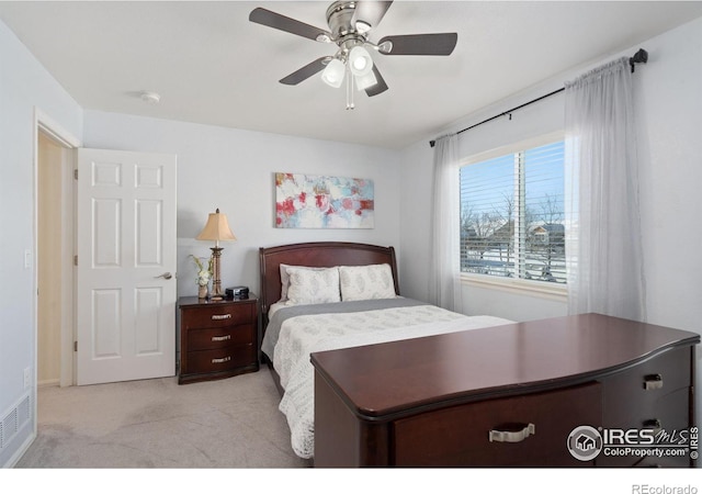 bedroom with light carpet and ceiling fan