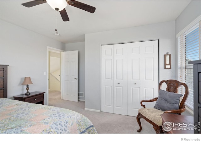 carpeted bedroom featuring a closet and ceiling fan