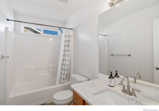 full bathroom featuring vanity, toilet, and shower / bathtub combination with curtain