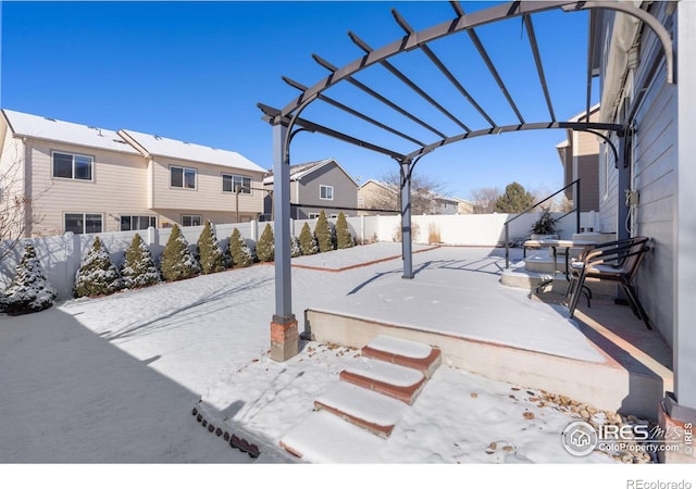 yard covered in snow featuring a pergola