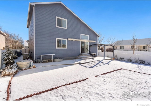 view of snow covered back of property