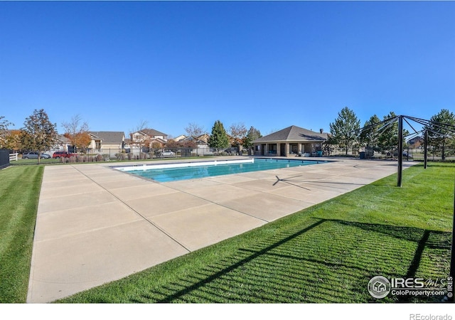 view of swimming pool with a patio area and a lawn