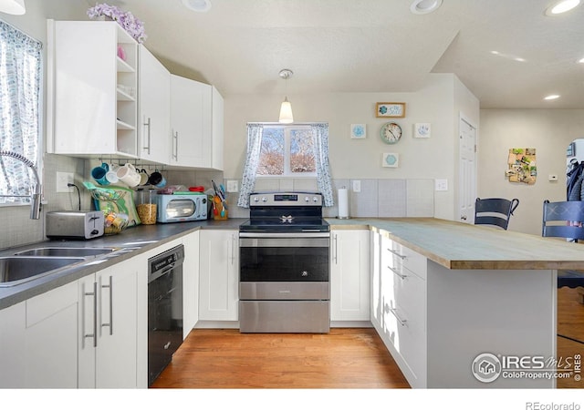 kitchen with kitchen peninsula, electric stove, decorative light fixtures, dishwasher, and white cabinetry