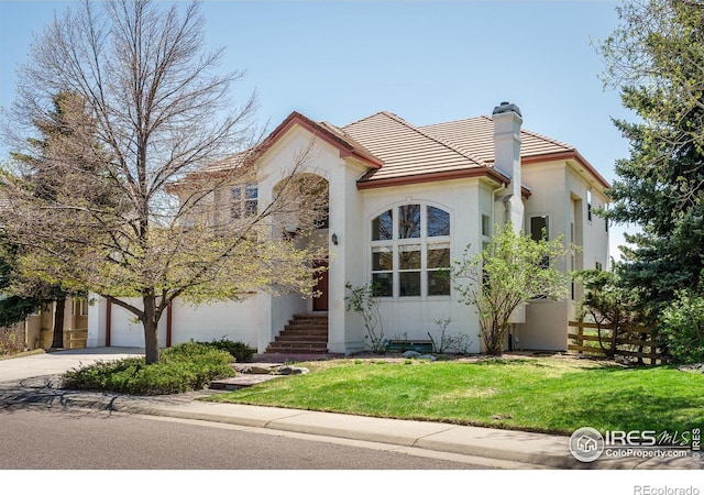 mediterranean / spanish home featuring a front yard