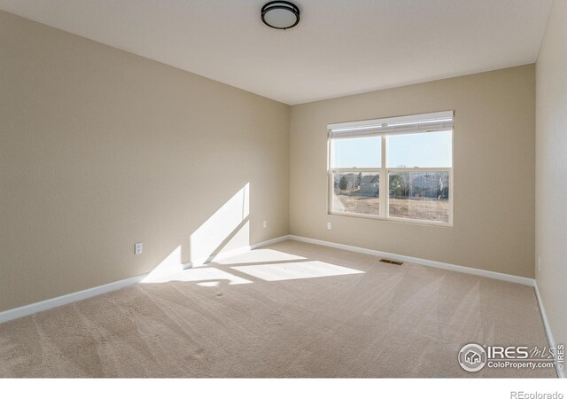 empty room featuring light carpet