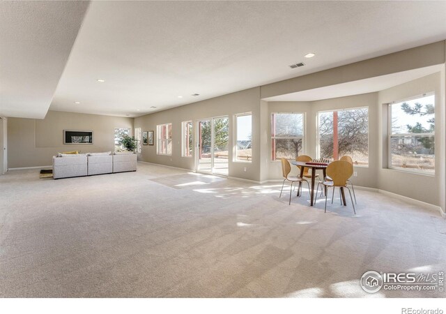 unfurnished living room featuring light colored carpet