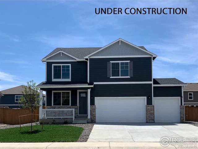 craftsman inspired home featuring covered porch and a garage