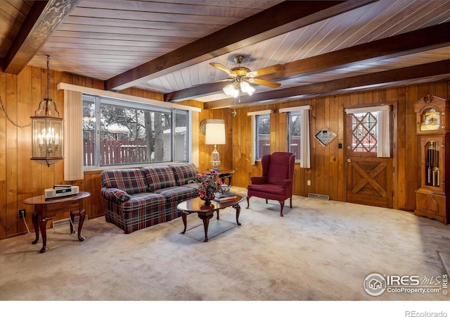 living room with wooden walls and a healthy amount of sunlight