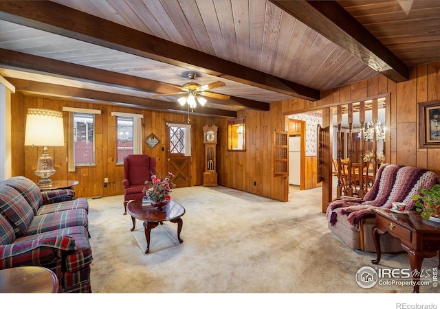 carpeted living room featuring ceiling fan, beam ceiling, wood ceiling, and wooden walls