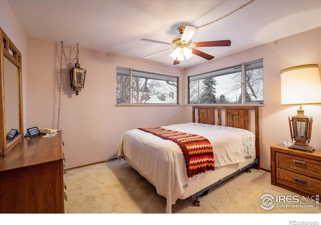 bedroom with ceiling fan and light colored carpet