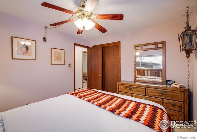 bedroom featuring ceiling fan and a closet