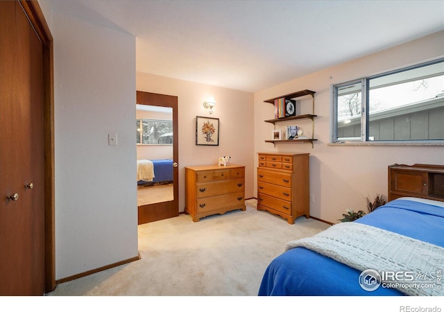 bedroom featuring light carpet and a closet