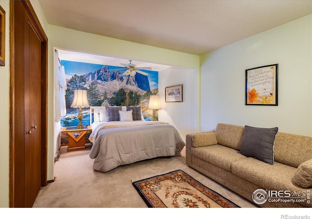 carpeted bedroom featuring ceiling fan and a closet