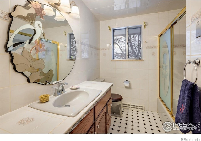 full bathroom with vanity, tile walls, enclosed tub / shower combo, tile patterned flooring, and toilet