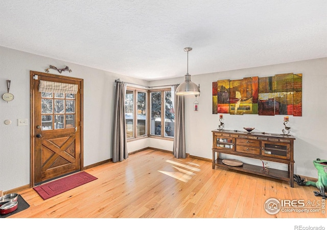 interior space with hardwood / wood-style floors and a textured ceiling