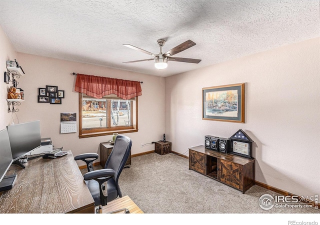 office space featuring a textured ceiling, ceiling fan, and light carpet