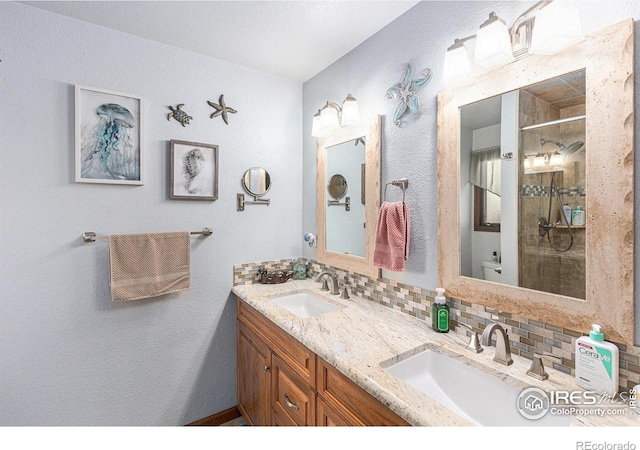 bathroom featuring tasteful backsplash, vanity, and an enclosed shower