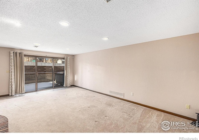 unfurnished living room with a textured ceiling and light carpet