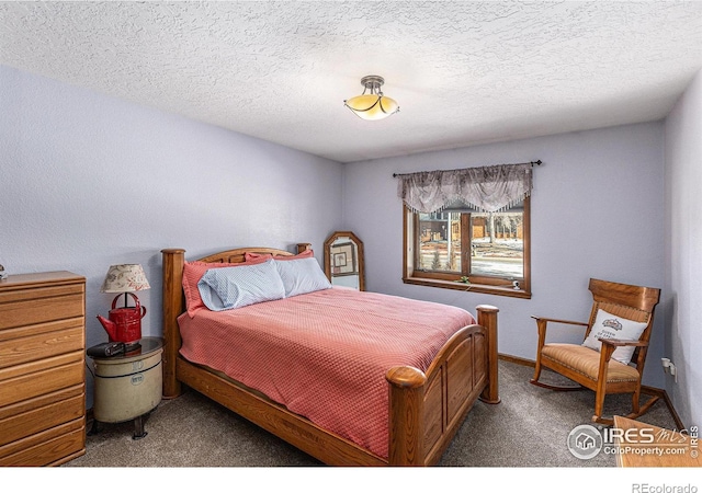 bedroom with carpet floors and a textured ceiling