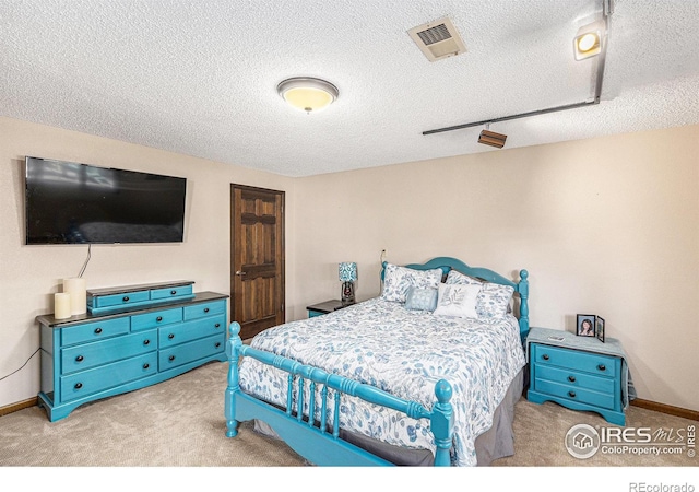 carpeted bedroom with a textured ceiling