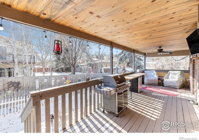 snow covered deck with ceiling fan and a grill