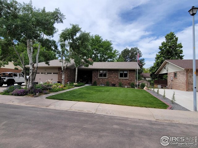 ranch-style home with a garage and a front lawn