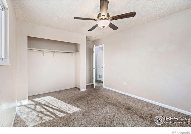 unfurnished bedroom with carpet, a textured ceiling, a closet, and ceiling fan