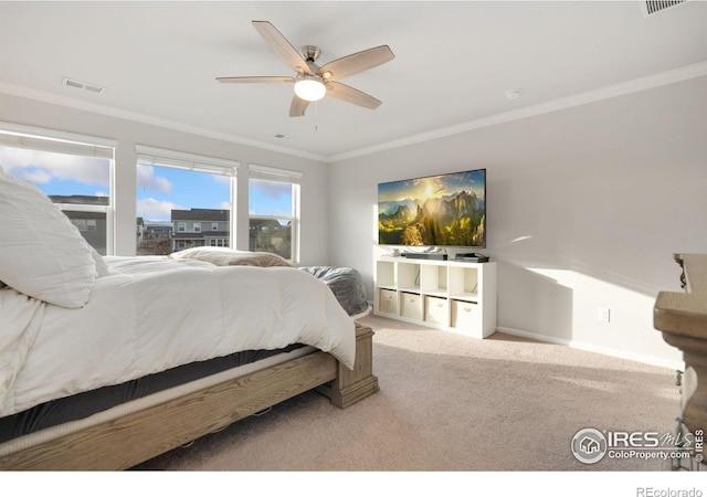 bedroom with carpet flooring, ceiling fan, and crown molding