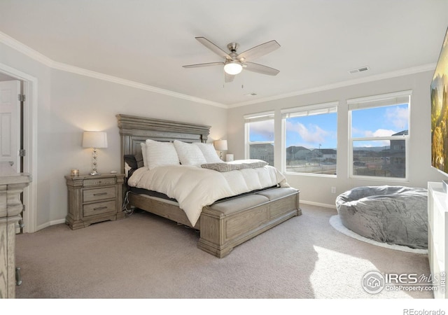 carpeted bedroom featuring ceiling fan and ornamental molding