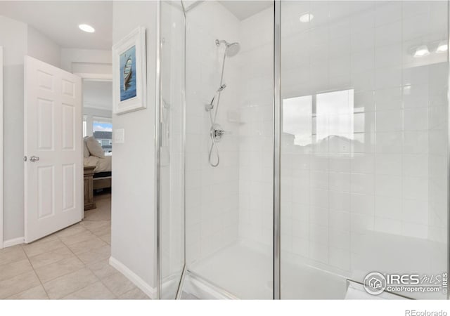 bathroom featuring tile patterned floors and a shower with shower door