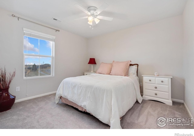 bedroom with ceiling fan and light carpet