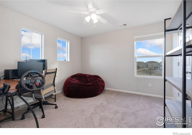 carpeted office with ceiling fan