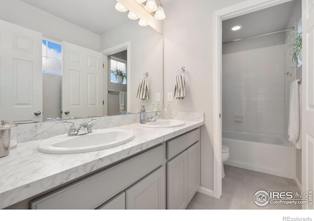 full bathroom with tile patterned flooring, vanity, toilet, and tiled shower / bath