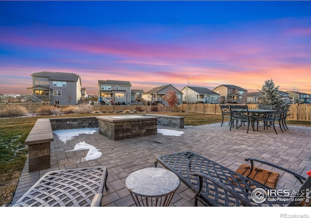 patio terrace at dusk with an outdoor fire pit