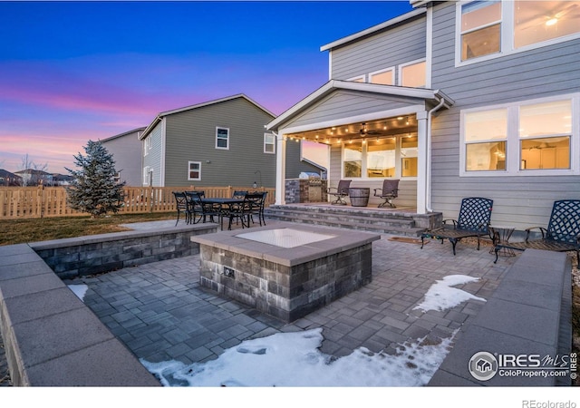 patio terrace at dusk with a fire pit