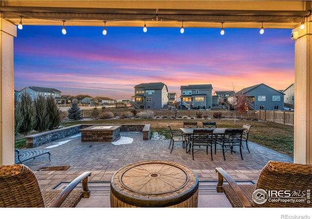 patio terrace at dusk with an outdoor fire pit